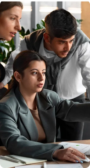 Marketing team working together at a computer