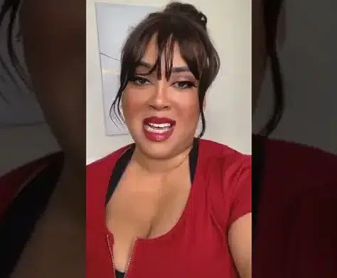 Client video testimonial thumbnail of a woman in a red top