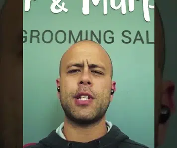 Client video testimonial thumbnail from a grooming salon owner