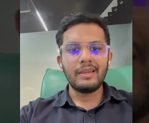 Client video testimonial thumbnail of a man in glasses