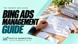 Hustle Marketers Bing Ads management guide with anonymous hands reviewing a physical search-ad planning kit.
